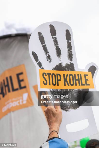 Demonstrators gather to protest against coal-based energy in front of the Chancellery in the "Stop Coal" protest event on June 24, 2018 in Berlin,...