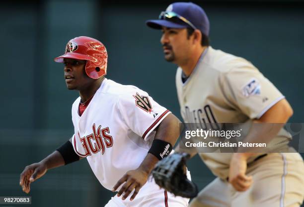 Justin Upton of the Arizona Diamondbacks leads off first base past infielder Adrian Gonzalez of the San Diego Padres during the Opening Day major...