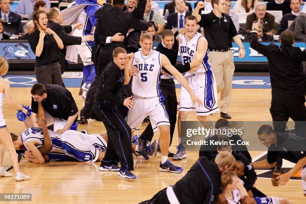 Mason Plumlee and Miles Plumlee of the Duke Blue Devils celebrate after the Blue Devils defeat the Butler Bulldogs 61-59 in the 2010 NCAA Division I...