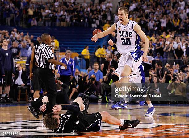 Jon Scheyer of the Duke Blue Devils celebrates after they won 61-59 against Matt Howard of the Butler Bulldogs during the 2010 NCAA Division I Men's...