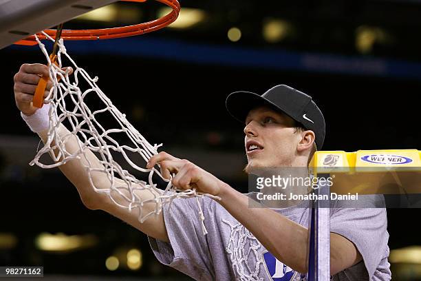 Kyle Singler of the Duke Blue Devils cuts down a piece of the net following their 61-59 win against the Butler Bulldogs during the 2010 NCAA Division...