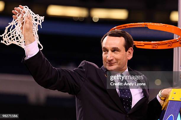 Head coach Mike Krzyzewski of the Duke Blue Devils cuts down a piece of the net following their 61-59 win against the Butler Bulldogs during the 2010...