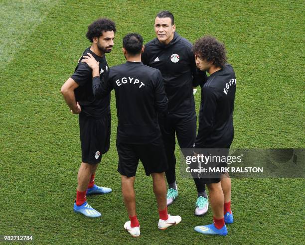 Egypt's forward Mohamed Salah talks with Egypt's goalkeeper Essam El Hadary and teammates during a training session at the Volgograd Arena in...