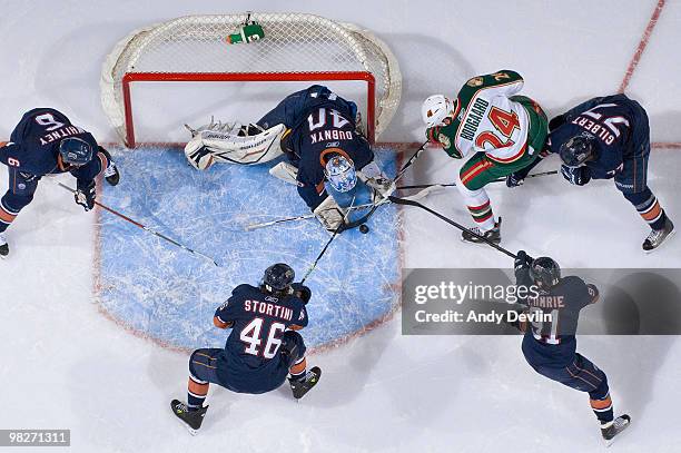 Derek Boogaard of the Minnesota Wild is surrounded by members of the Edmonton Oilers in the crease at Rexall Place on April 5, 2010 in Edmonton,...