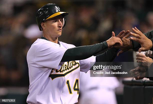 Mark Ellis of the Oakland Athletics celebrates after scoring in the seventh inning against the Seattle Mariners on Opening Day at the Oakland-Alameda...