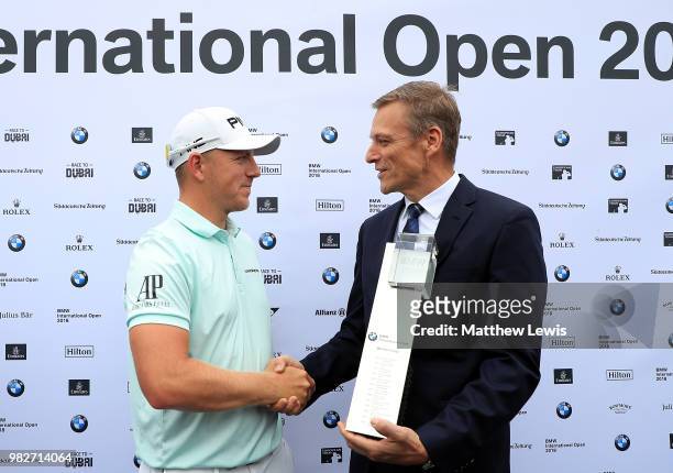 Matt Wallace of England is presented the trophy by Peter van Binsbergen, Head of the German Sales Subsidiary for the BMW Group after winning the BMW...