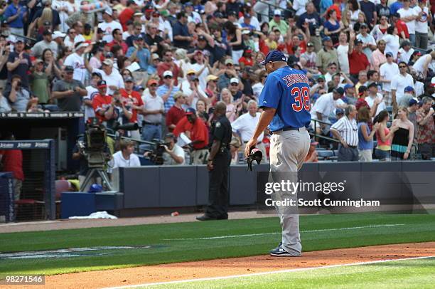 Carlos Zambrano of the Chicago Cubs heads off the field after being pulled in the 2nd inning against the Atlanta Braves during Opening Day at Turner...