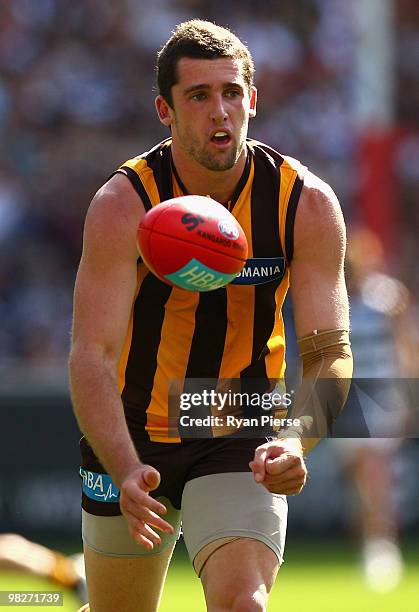 Brent Renouf of the Hawks handballs during the round two AFL match between the Hawthorn Hawks and the Geelong Cats at Melbourne Cricket Ground on...