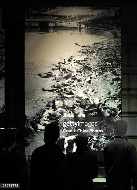 Visitors view documents at the Memorial Hall of the Victims in the Nanjing Massacre, as tens of thousands of people come to mourn victims a day...