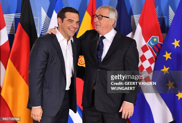 European Commission President Jean-Claude Juncker speaks with Greek Prime Minister Alexis Tsipras during an informal EU summit on migration issues at...