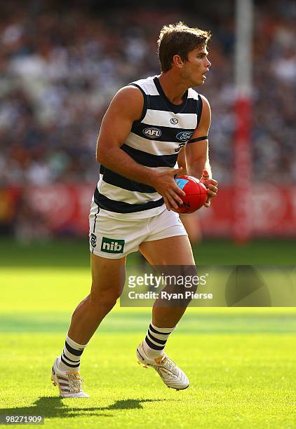 Tom Hawkins of the Cats runs with the the ball during the round two AFL match between the Hawthorn Hawks and the Geelong Cats at Melbourne Cricket...