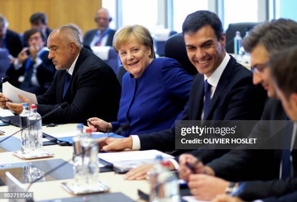 German Chancellor Angela Merkel speaks with Spanish Prime Minister Pedro Sanchez alongside Bulgaria's Prime Minister Boyko Borissov during a summit...