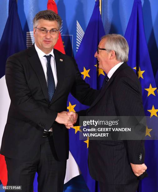 European Commission President Jean-Claude Juncker shakes hands with Croatian Prime Minister Andrej Plenkovic ahead of an informal EU summit on...