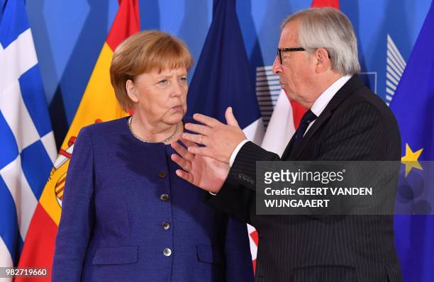 European Commission President Jean-Claude Juncker speaks with German Chancellor Angela Merkel during an informal EU summit on migration issues at EU...