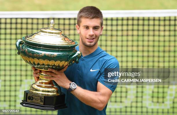 Borna Coric from Croatia poses with his trophy after defeating Roger Federer of Switzerland in their final match at the ATP tennis tournament in...