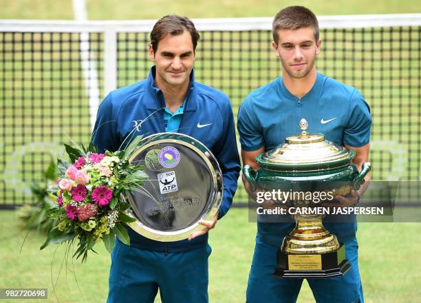 Borna Coric from Croatia poses with Roger Federer of Switzerland after defeating him in their final match at the ATP tennis tournament in Halle,...