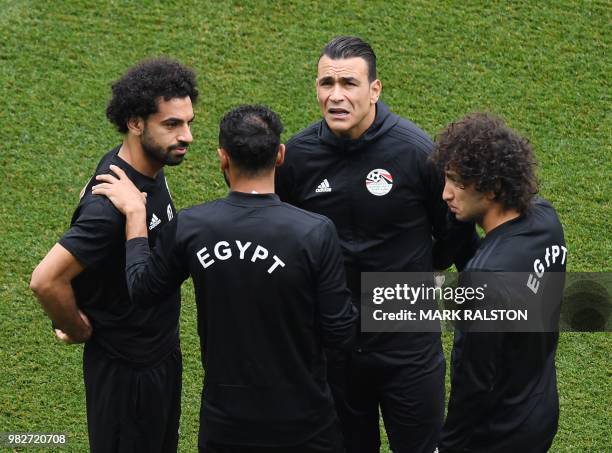 Egypt's forward Mohamed Salah talks with Egypt's goalkeeper Essam El Hadary and teammates during a training session at the Volgograd Arena in...