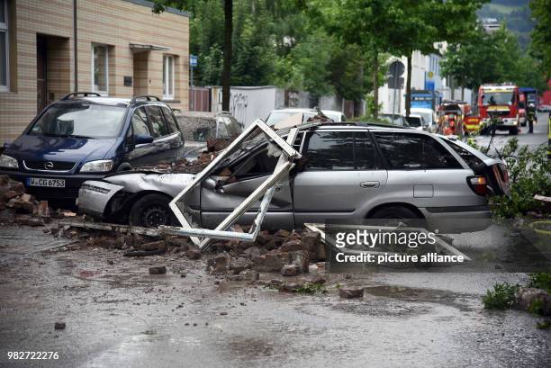 Dpatop - 24 June 2018, Wuppertal, Germany: A car wreck stands in front of the ruins of a house where there was an explosion during the night. In an...