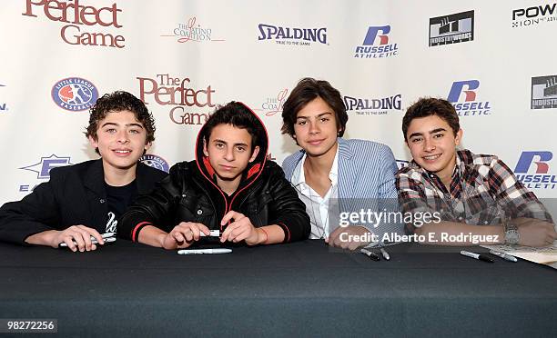 Actor Ryan Ochoa, actor Moises Arias, actor Jake T. Austin and actor Jansen Panettiere sign posters at an autograph session prior to the premiere of...