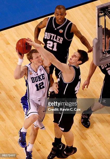 Kyle Singler of the Duke Blue Devils goes up for a shot against Andrew Smith of the Butler Bulldogs during the 2010 NCAA Division I Men's Basketball...