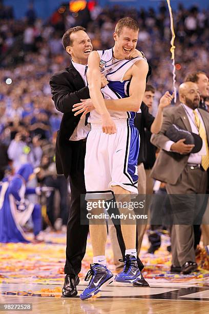 Associate head coach Chris Collins and Jon Scheyer of the Duke Blue Devils celebrate after the Blue Devils defeat the Butler Bulldogs 61-59 in the...