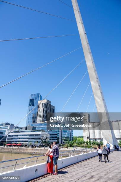 Couple on the Puente De La Mujer, pedestrian suspension swing bridge.