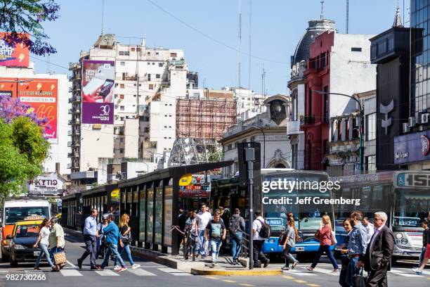 Argentina, Buenos Aires, Belgrano, busy street with pedestrians and bus traffic.