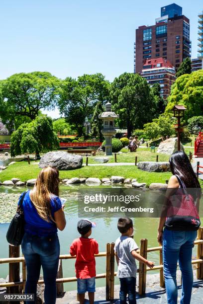 Argentina, Buenos Aires, Recoleta, Japanese Garden, Carp Lake and boardwalk with tourists.