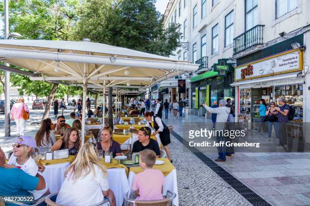 Portugal, Lisbon, Rossio Square, Cafe Gelo busy sidewalk cafŽ tables.