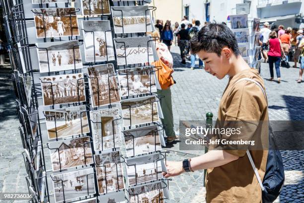 Portugal, Lisbon, Castelo quarter, person shopping for postcards.