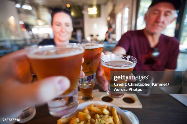 celebratory toast with beer - dunsborough stock pictures, royalty-free photos & images