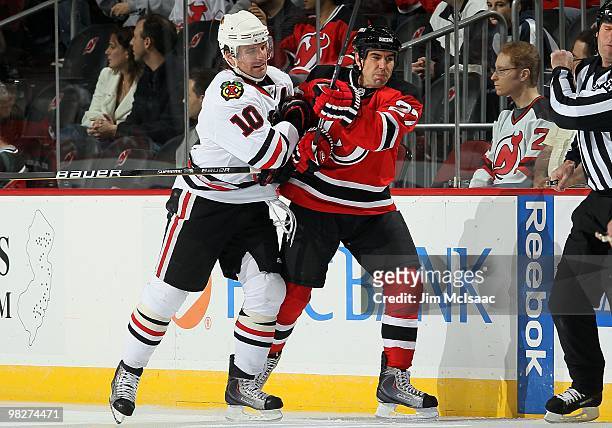 Patrick Sharp of the Chicago Blackhawks skates against Mike Mottau of the New Jersey Devils at the Prudential Center on April 2, 2010 in Newark, New...