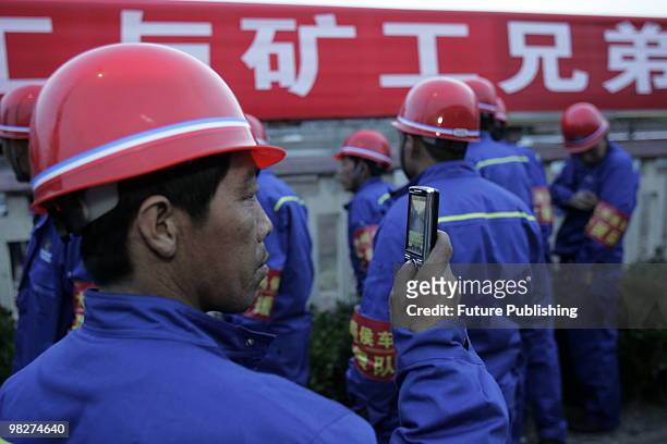 Railway workers see off the train carrying 60 rescued miners in a critical condition at the railway station April 06, 2010 in Hejin, China. Rescuers...