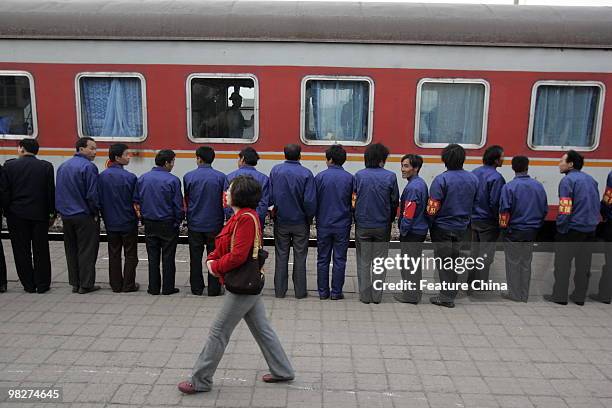 Railway workers see off the train carrying 60 rescued miners in a critical condition at the railway station April 06, 2010 in Hejin, China. Rescuers...