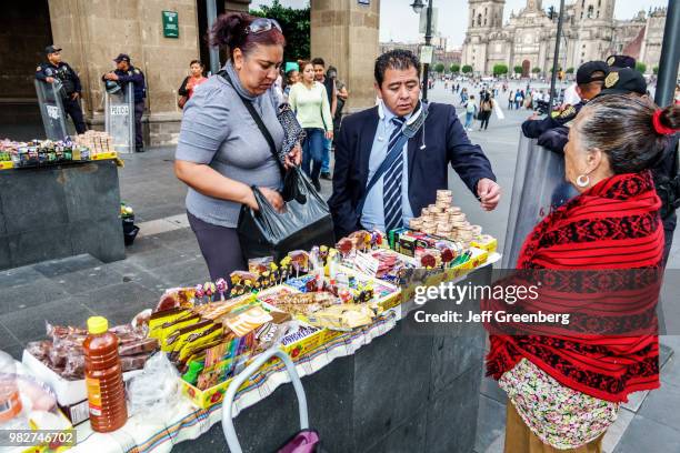 Mexico City, Plaza de la Constitucion, tourists paying food vendor.