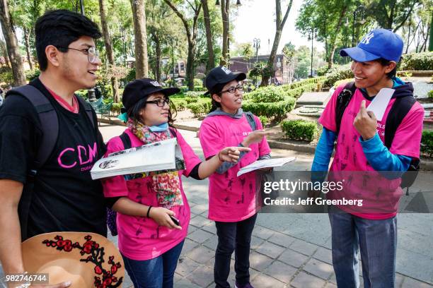 Mexico City, Jardin Plaza Hidalgo, taking survey questionnaire opinion poll.