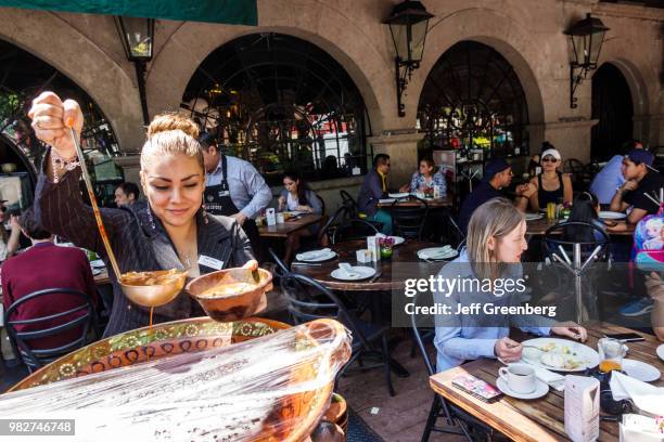 Mexico City, Restaurante Cabo Coyote, woman serving traditional food.