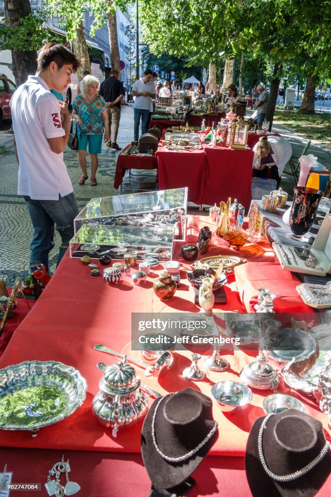 Portugal, Lisbon, Avenida Da Liberdade, Antiques Fair vendor and shoppers