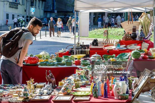 Portugal, Lisbon, Avenida Da Liberdade, Antiques Fair vendor and shoppers.