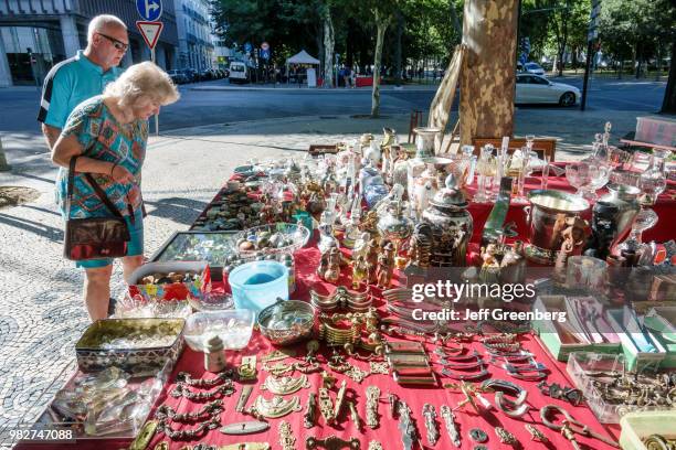 Portugal, Lisbon, Avenida Da Liberdade, Antiques Fair vendor and shoppers.