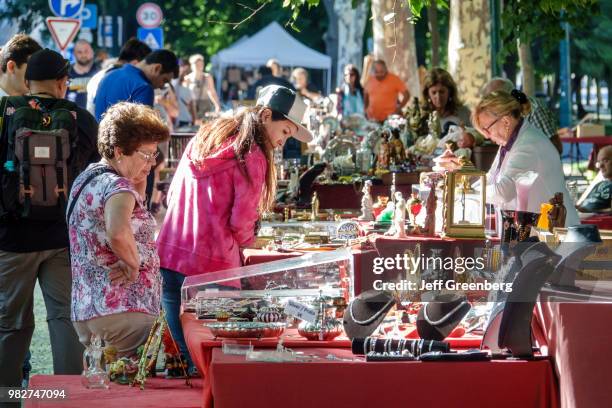 Portugal, Lisbon, Avenida Da Liberdade, Antiques Fair vendor and shoppers.