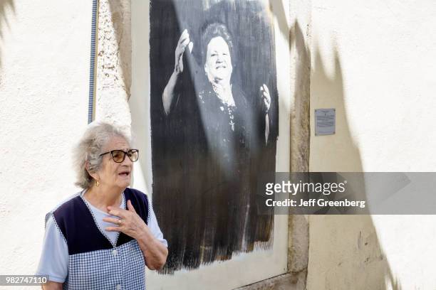 Portugal, Lisbon, Mouraria, mural and traditional singer.