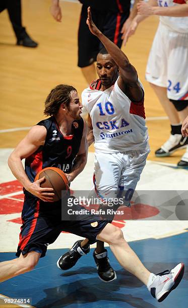 Marcelinho Huertas, #9 of Caja Laboral competes with J.R. Holden, #10 of CSKA Moscow during the Euroleague Basketball 2009-2010 Play Off Game 4...
