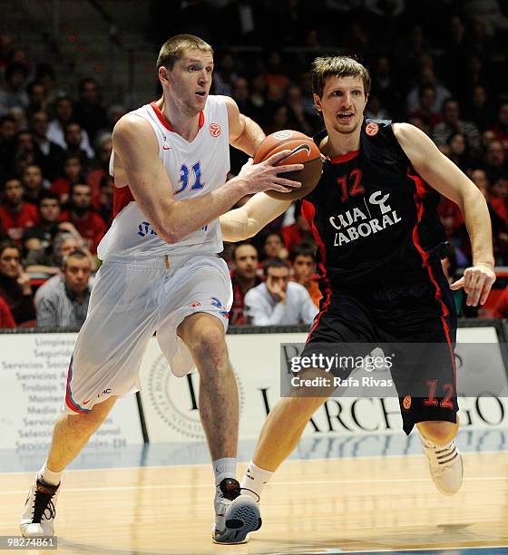 Viktor Khryapa, #31 of CSKA Moscow competes with Mirza Teletovic, #12 of Caja Laboral during the Euroleague Basketball 2009-2010 Play Off Game 4...