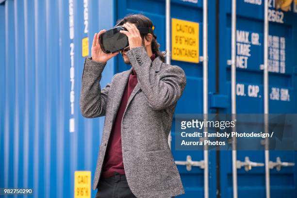 man in blazer using vr goggles - vr goggles business stockfoto's en -beelden