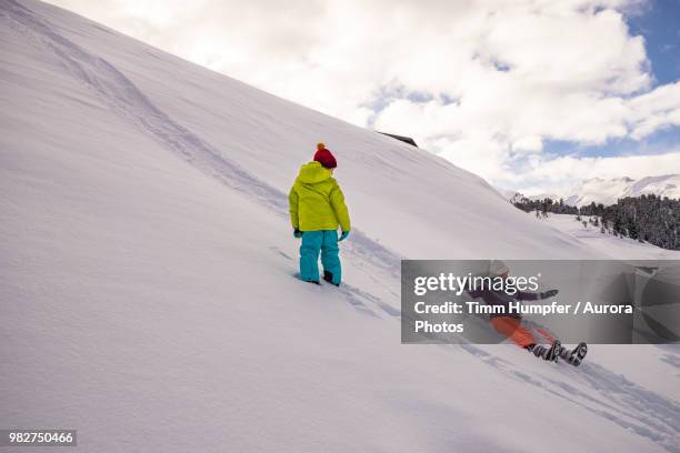 woman sliding down hill in winter - obergurgl stock pictures, royalty-free photos & images