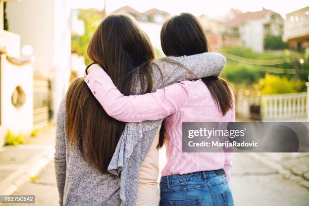 hugging best friend - always with a smile stock pictures, royalty-free photos & images