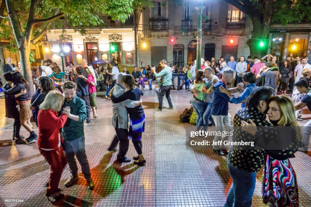 Tango dancers performing at Plaza Dorrego at night.