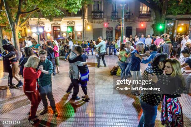 Tango dancers performing at Plaza Dorrego at night.