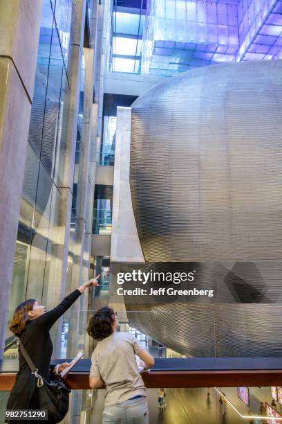 Woman and boy looking at the La Ballena Azul, blimp-shaped auditorium inside the Centro Cultural Kirchner.